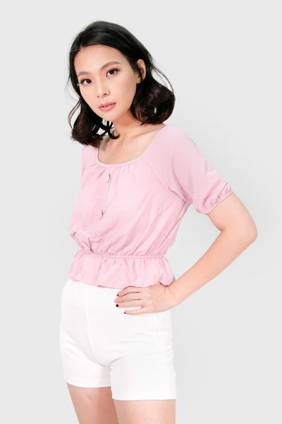 Pink peplum with cloth button